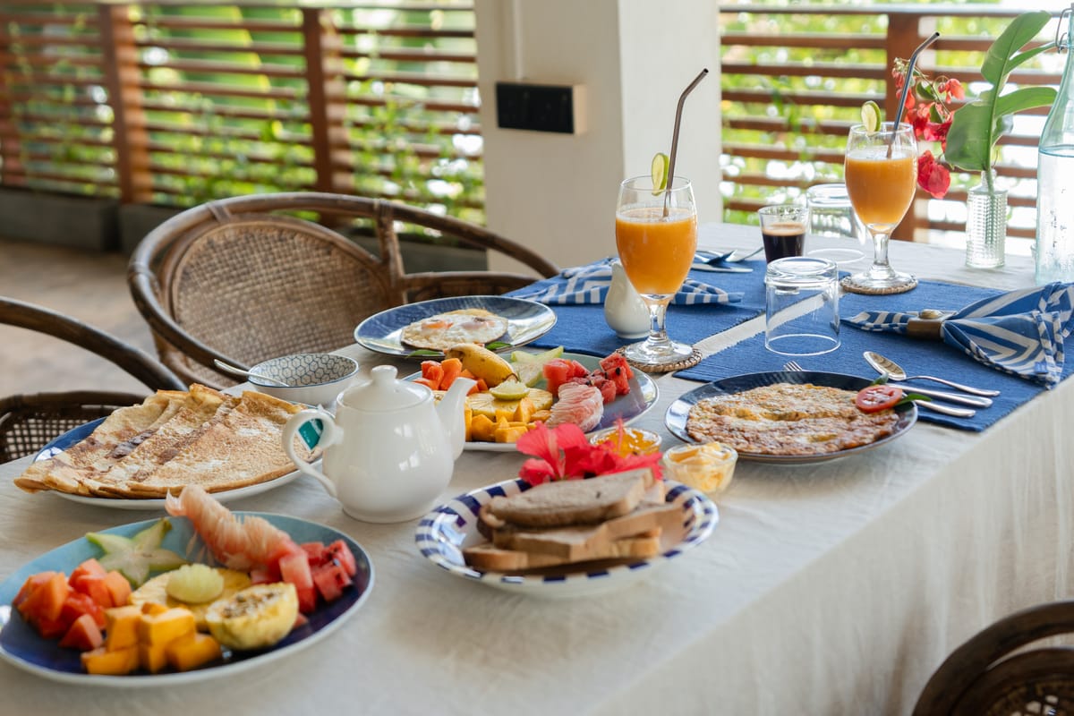 The breakfast table laid, fresh juices and fruit